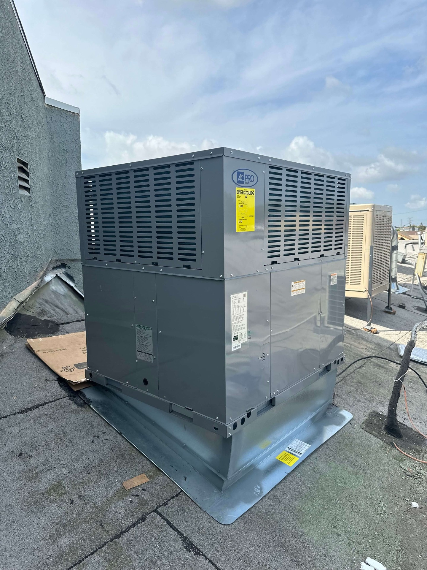 AC Pro commercial package unit on a flat roof